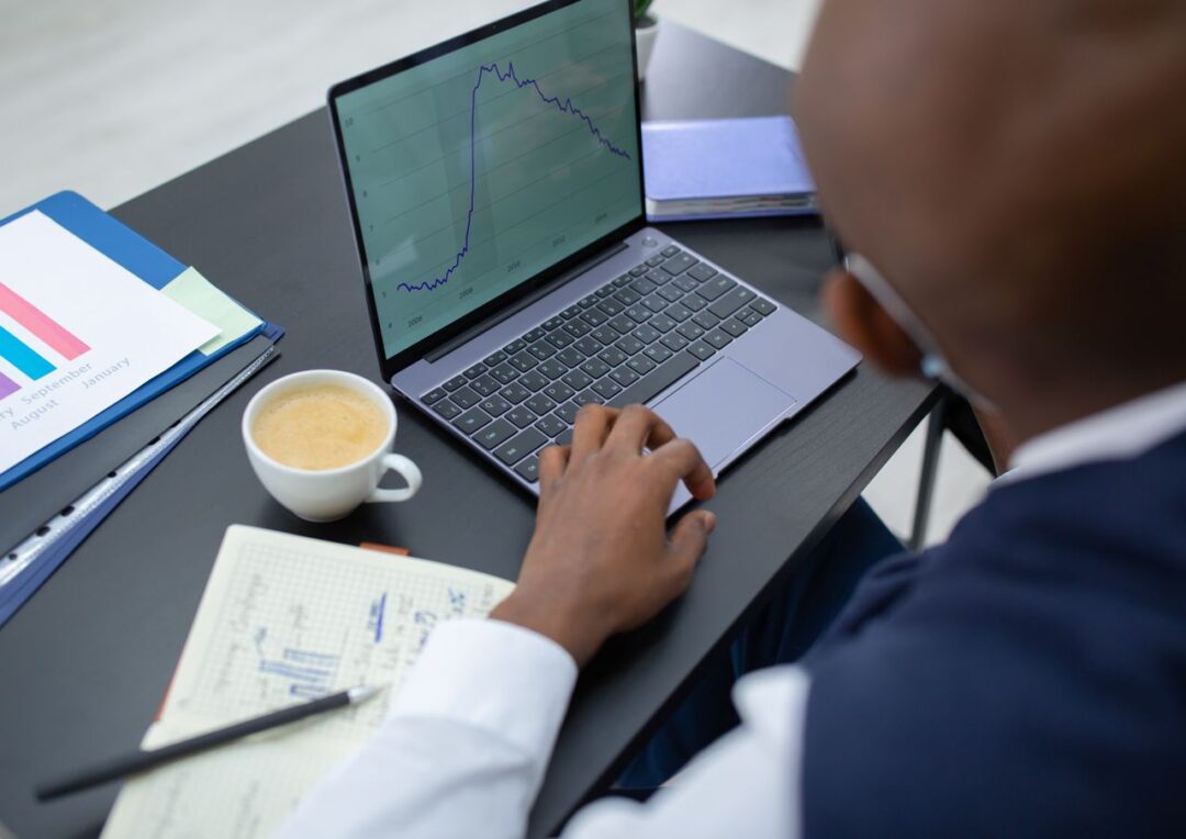 Laptop and reports showing business performance data